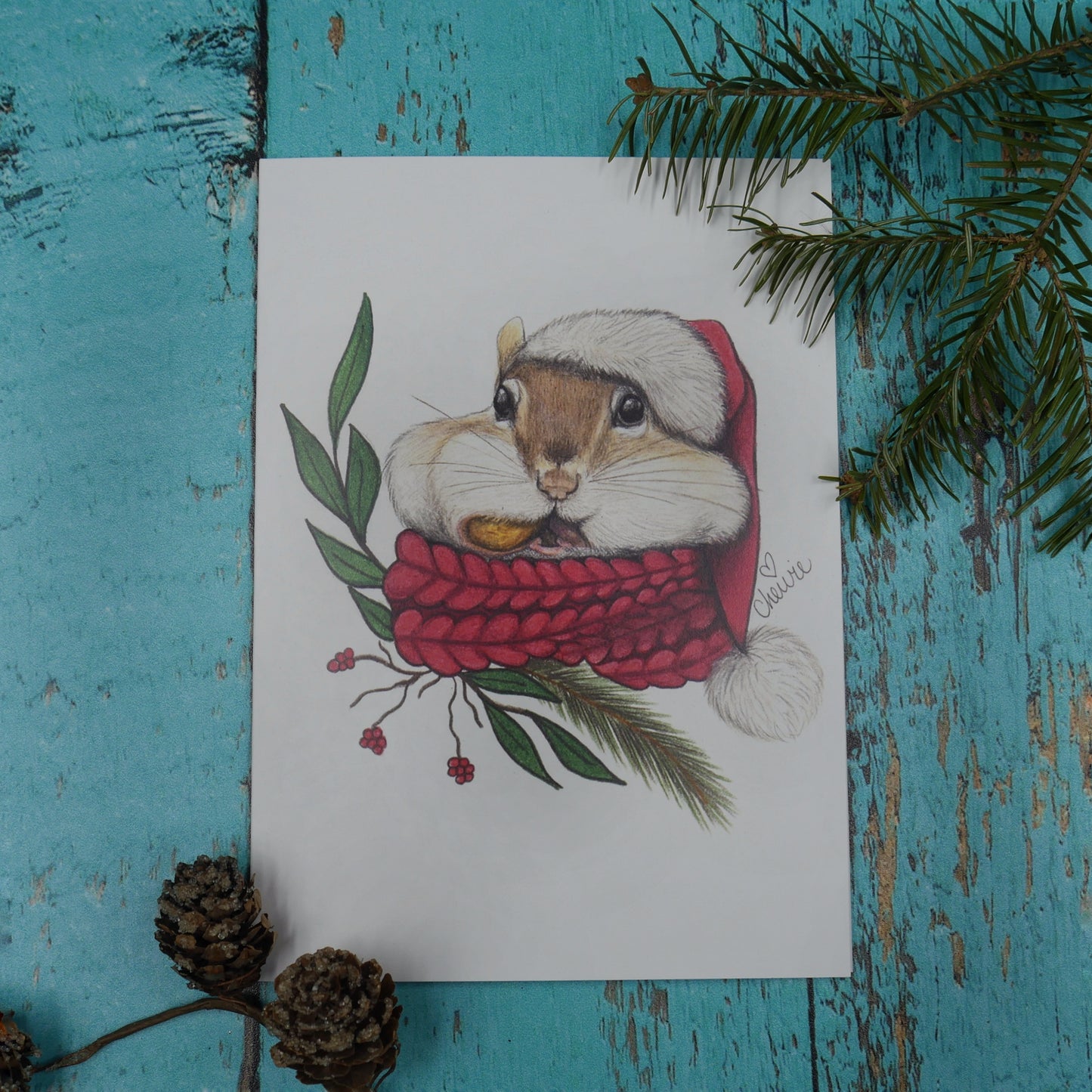 Carte de souhaits tamia avec un foulard et un chapeau de Noël