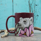 Tasse bordeau ours polaire entouré de fleurs roses