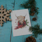 Carte de vœux vache highland avec foulard rouge et branches de sapin